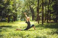 Anjaneyasana. Yoga asanas in nature. Yoga poses everyday. Practicing young woman. Yoga in the park