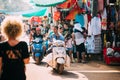 Anjuna, Goa, India. Men Riding On Scooter Motorcycle In The Anjuna Market.