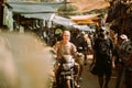 Anjuna, Goa, India - February 19, 2020: old Man Riding On Scooter Motorcycle In The Anjuna Market