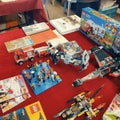 Second hand Lego minifigures, vehicles, Star Wars space ships, boxed Lego toys and old books on the showcase in sunday flea Royalty Free Stock Photo