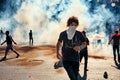 Male protester running away from the tear gas smoke fired by the police during Gezi park protests in Ankara, Turkey