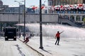 Protesters struggling against the police water cannon while it shoots high velocity stream of water during Gezi park protests in