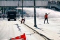 Protesters trying to stand against the police water cannon while it shoots high velocity stream of water during Gezi park protests