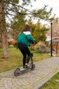 Ankara/Turkey - March 15 2020: Back view of girl rides electric scooter of Marti Tech in kugulu park
