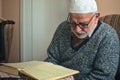 Ankara/Turkey - 24.04.2020: Very old Turkish muslim man reciting Qur`an in Ramadan Royalty Free Stock Photo