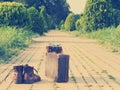 Ankle boots, cardboard suitcase, film camera, brick road. Post-processed.