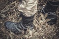 Ankle military boots on the feet of a young soldier in a camouflage Royalty Free Stock Photo