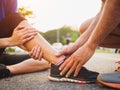 Ankle sprained. Young woman suffering from an ankle injury while Royalty Free Stock Photo