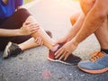 Ankle sprained. Young woman suffering from an ankle injury while Royalty Free Stock Photo