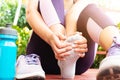 Ankle sprained. Young woman suffering from an ankle injury while exercising and running. Healthcare and sport concept.