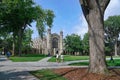 campus with lawn and trees in front of gothic architecture buildings