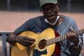 An elderly African American street musician