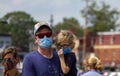 A caucasian family wearing masks outdoors