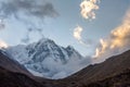 Annapurna South Mountain and clouds during golden hour after sunrise, Himalayas Royalty Free Stock Photo