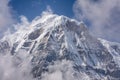 Annapurna South Summit surrounded by rising clouds in Himalayas Royalty Free Stock Photo