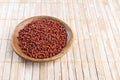 Annatto seeds on rustic wood