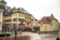 ANNECY, FRANCE-APRIL 3, 2019: The Tioux River embankment in the Old Town, surrounding a medieval palace located in the middle of Royalty Free Stock Photo