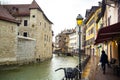 ANNECY, FRANCE-APRIL 3, 2019: The Tioux River embankment in the Old Town, surrounding a medieval palace located in the middle of Royalty Free Stock Photo