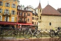 ANNECY, FRANCE-APRIL 3, 2019: The Tioux River embankment in the Old Town, surrounding a medieval palace located in the middle of Royalty Free Stock Photo