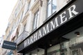 Warhammer text brand and logo sign on entrance facade boutique toys Games Workshop store Fantasy