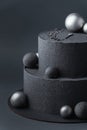 Anniversary luxury black bunk cake with chocolate velvet coating on dark grey background. Birthday cake with black velvet texture Royalty Free Stock Photo