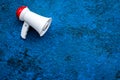 Announcement concept. Megaphone on blue background top view copy space