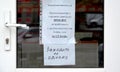 Announcement on the door of the shopping pavilion `Come in one at a time.` Russian text - please observe the distance of 1.5 m