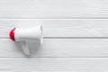 Announcement with megaphone on white wooden background top view mockup