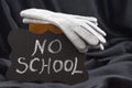 NO SCHOOL sign on chalkboard against black satin warns of cold w