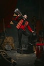 Announcement. Poster. Ringmaster, magician in red coat shouting into megaphone over dark retro circus backstage Royalty Free Stock Photo