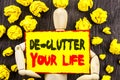 Announcement text showing De-Clutter Your Life. Concept meaning Free Less Chaos Fresh Clean Routine written on Sticky Note Holding Royalty Free Stock Photo