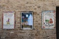 Announcements of performances on old stone wall in Grazzano Visconti castle