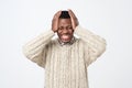 african american man in sweater in panic, shocked to hear bad news. Stressful situation concept