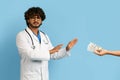 Annoyed angry doctor refusing to take bribe Royalty Free Stock Photo