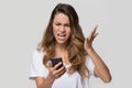 Annoyed angry woman mad about stuck phone isolated on background Royalty Free Stock Photo