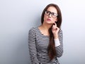 Annoyed angry young woman in eyeglasses thinking and looking up