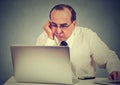 Annoyed bored man learning how to use computer Royalty Free Stock Photo