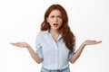 Annoyed and confused redhead business woman shrugging, staring frustrated at camera, cant understand wtf going on