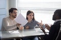 Annoyed couple arguing with bank manager dissatisfied by mortgage rate