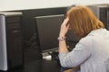 Annoyed female mature student working on computer Royalty Free Stock Photo