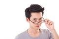 Annoyed genius nerd man looking at you, hand holding eyeglasse Royalty Free Stock Photo