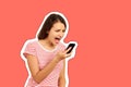 Annoyed hysterical young woman screams into mobile phone, the girl is displeased with the conversation. emotional girl Magazine