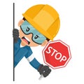 Annoyed industrial mechanical worker peeking out from behind a wall holding stop sign. Construction worker with his personal