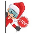 Annoyed industrial mechanical worker with Santa Claus hat peeking out from behind a wall holding stop sign. Merry christmas.