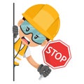 Annoyed industrial worker peeking out from behind a wall holding stop sign. Construction worker with his personal protective