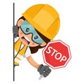 Annoyed industrial worker woman peeking out from behind a wall holding stop sign. Construction worker with his personal protective