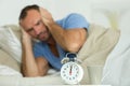 annoyed man covering ears in morning Royalty Free Stock Photo