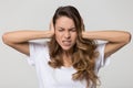 Annoyed stressed woman covering ears with hands feeling ear pain