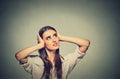 Annoyed stressed woman covering her ears, looking up loud noise Royalty Free Stock Photo