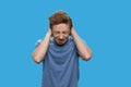 Annoyed teen boy closing his ears with hands. Royalty Free Stock Photo